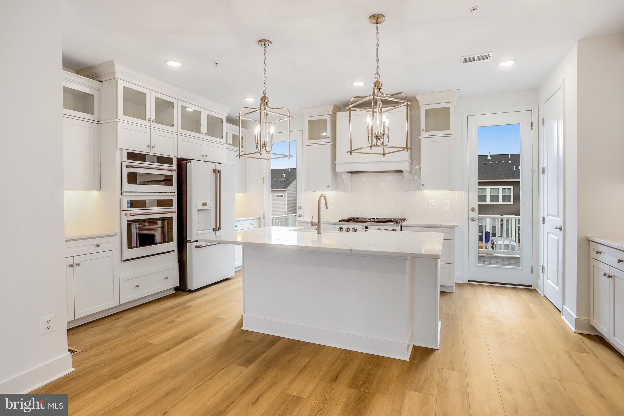 1885 Shookstown Road Frederick, MD 21702 - Photo 11 of 47 a kitchen with stainless steel appliances granite countertop a refrigerator a stove and a wooden floors
