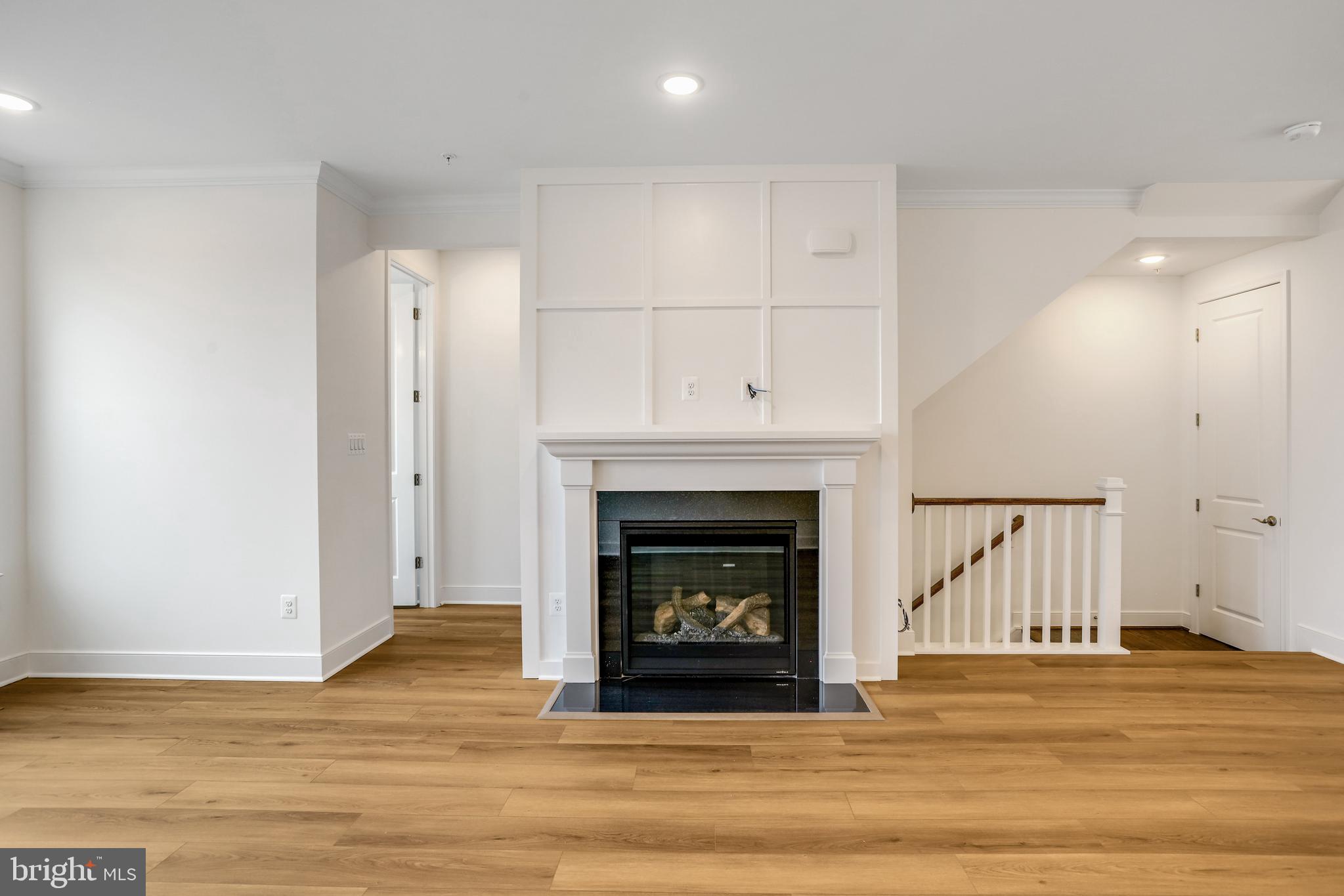 1885 Shookstown Road Frederick, MD 21702 - Photo 23 of 47 a view of an empty room with wooden floor and a fireplace