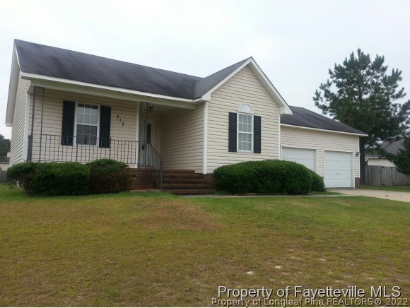 513 Kernstown Road Raeford, NC 28376 - Photo 1 of 24 a view of a house with a yard and garage
