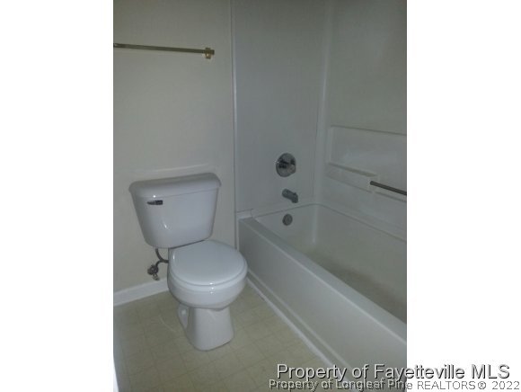 513 Kernstown Road Raeford, NC 28376 - Photo 11 of 24 a bathroom with a toilet and a bathtub