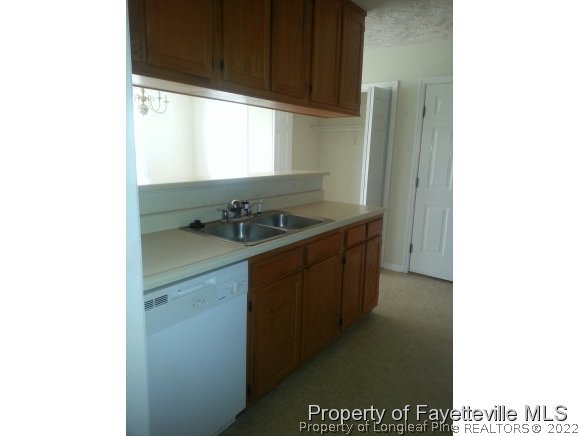 513 Kernstown Road Raeford, NC 28376 - Photo 4 of 24 a kitchen with a sink and cabinets