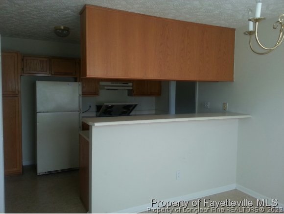 513 Kernstown Road Raeford, NC 28376 - Photo 6 of 24 a kitchen with a refrigerator and a sink