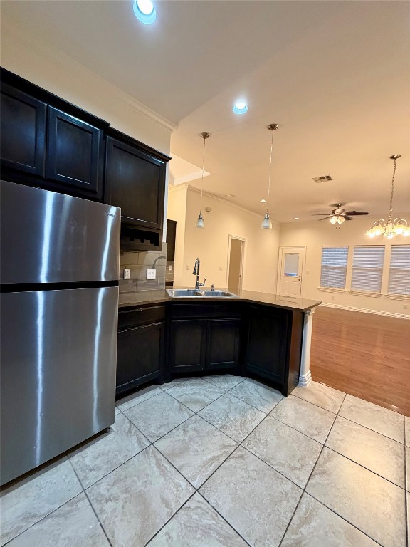 398 Mesa Drive, Unit C Del Valle, TX 78617 - Photo 11 of 21 a kitchen with a refrigerator and a sink