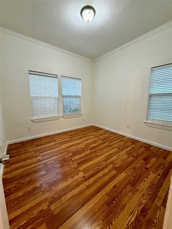 398 Mesa Drive, Unit C Del Valle, TX 78617 - Photo 20 of 21 a view of an empty room with wooden floor and a window