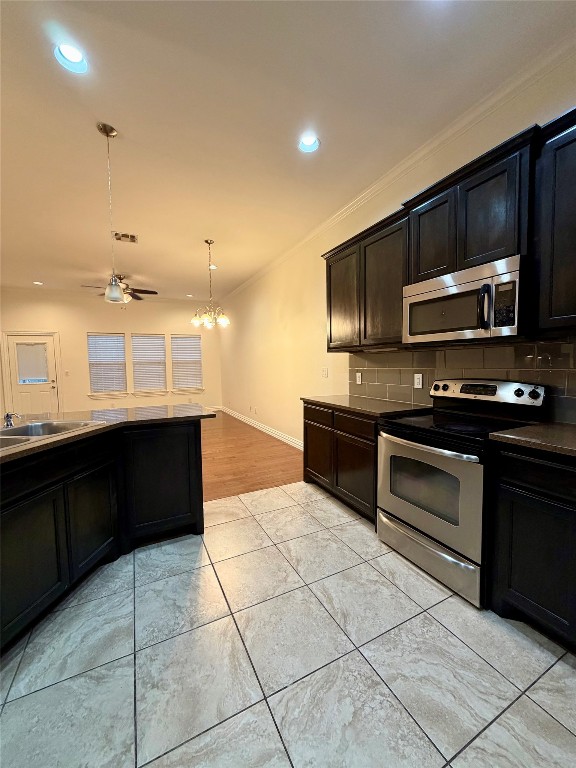 398 Mesa Drive, Unit C Del Valle, TX 78617 - Photo 10 of 21 a kitchen with stainless steel appliances granite countertop a stove a sink and a microwave