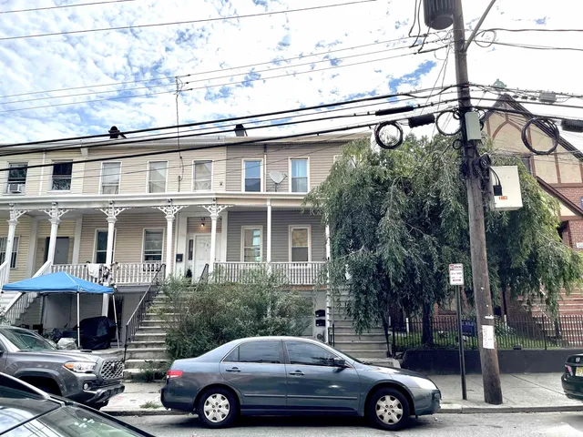 a front view of a house with parking area
