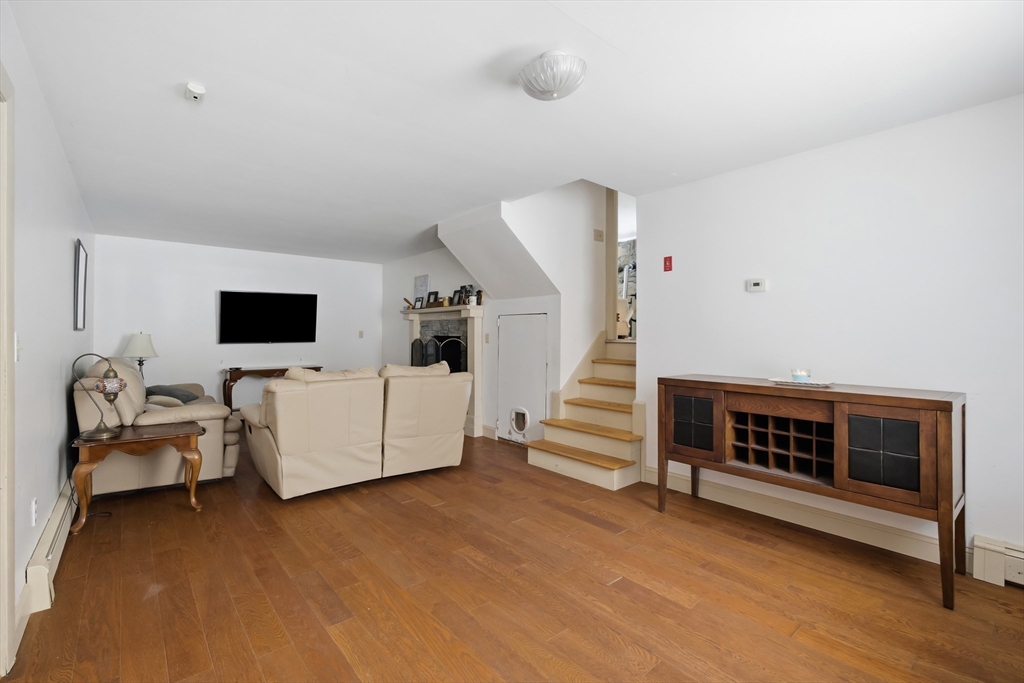 79 High Street Uxbridge, MA 01569 - Photo 12 of 35 a living room with furniture and a flat screen tv