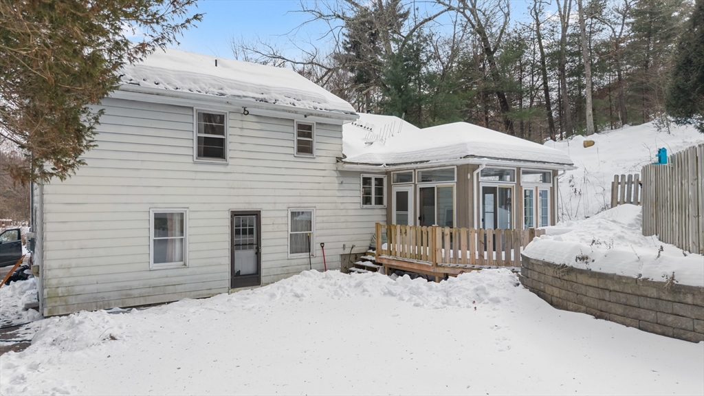 79 High Street Uxbridge, MA 01569 - Photo 30 of 35 a front view of a house with a wooden fence