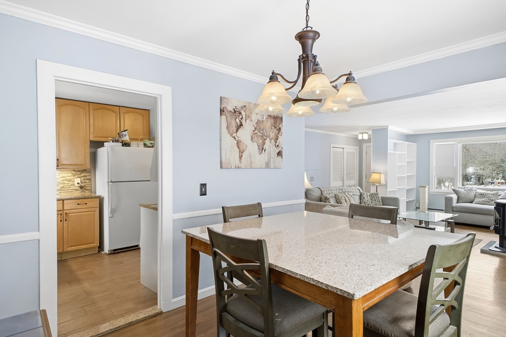 79 High Street Uxbridge, MA 01569 - Photo 6 of 35 a dining room with a table chairs and kitchen view