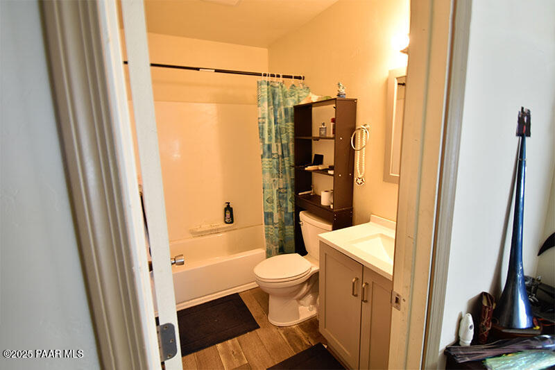 3200 North Victor Road Prescott Valley, AZ 86314 - Photo 15 of 30 a bathroom with a granite countertop sink toilet and shower