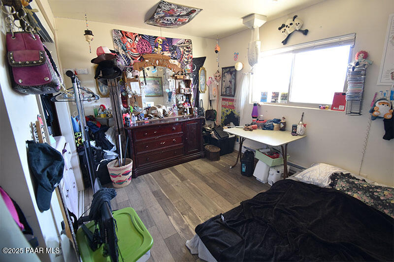 3200 North Victor Road Prescott Valley, AZ 86314 - Photo 24 of 30 a bedroom with a bed closet and a mirror