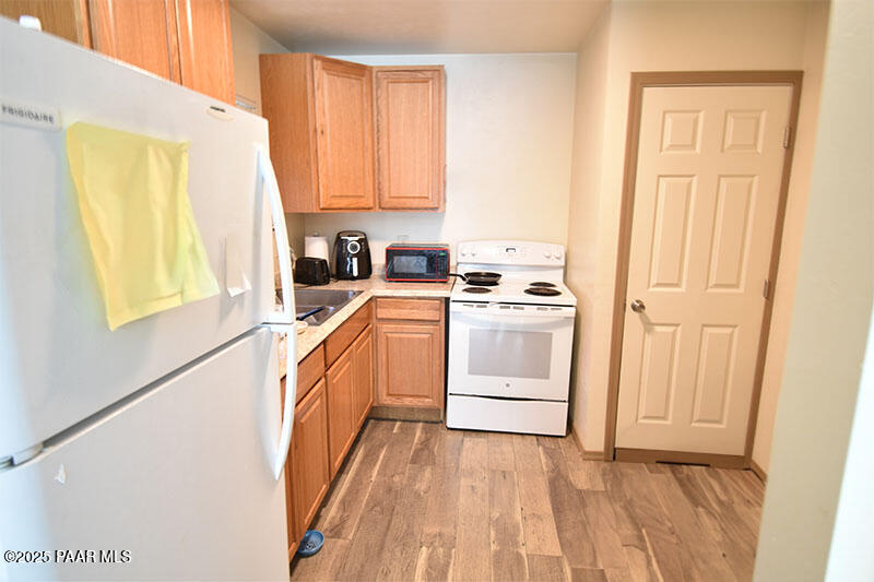 3200 North Victor Road Prescott Valley, AZ 86314 - Photo 6 of 30 a kitchen with white cabinets and white appliances