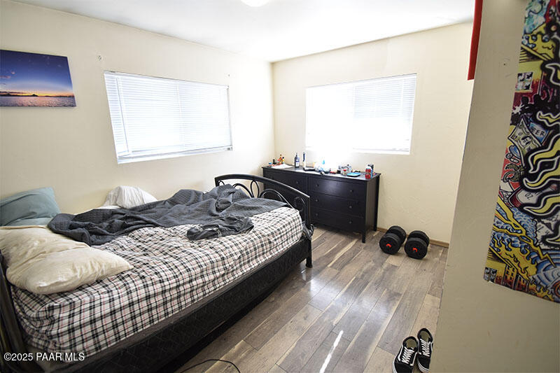 3200 North Victor Road Prescott Valley, AZ 86314 - Photo 8 of 30 a bedroom with a bed and wooden floor