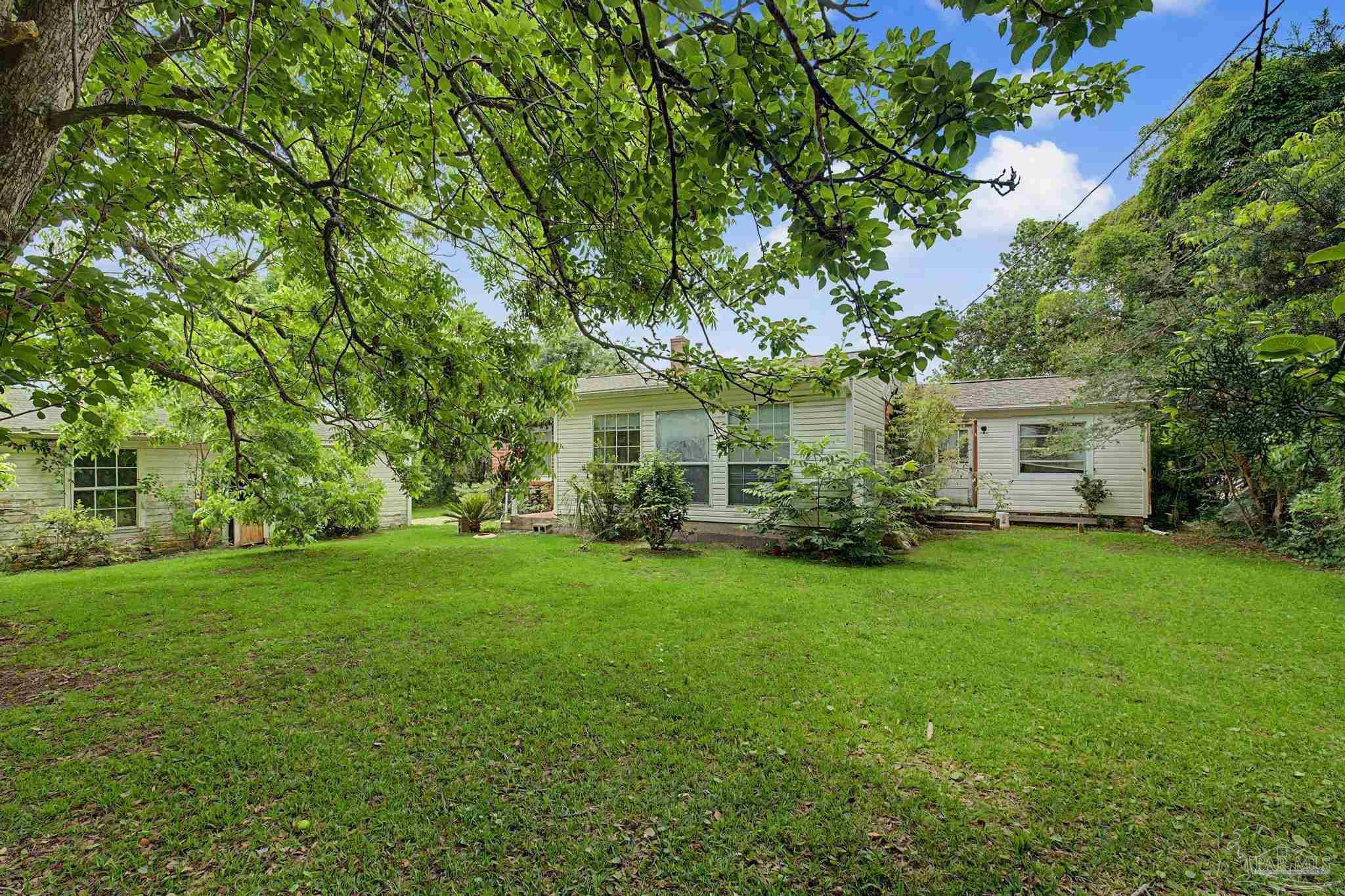 333 Gibbs Road Pensacola, FL 32507 - Photo 30 of 34 a view of a house with backyard sitting area and garden