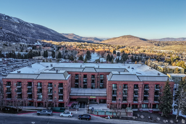 50 Shadow Ridge Road, Unit 4209 Park City, UT 84060 - Photo 47 of 50 Brick exterior with multiple balconies, a snow-dusted roof, and surrounding mountainous terrain