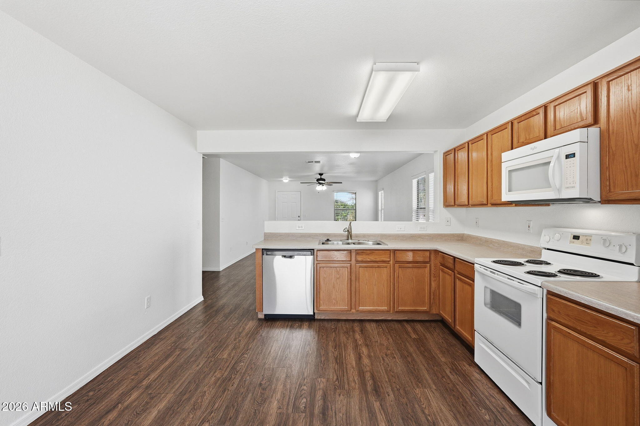 211 East Valley View Drive Phoenix, AZ 85042 - Photo 17 of 47 a kitchen with granite countertop a sink cabinets stainless steel appliances and a counter space