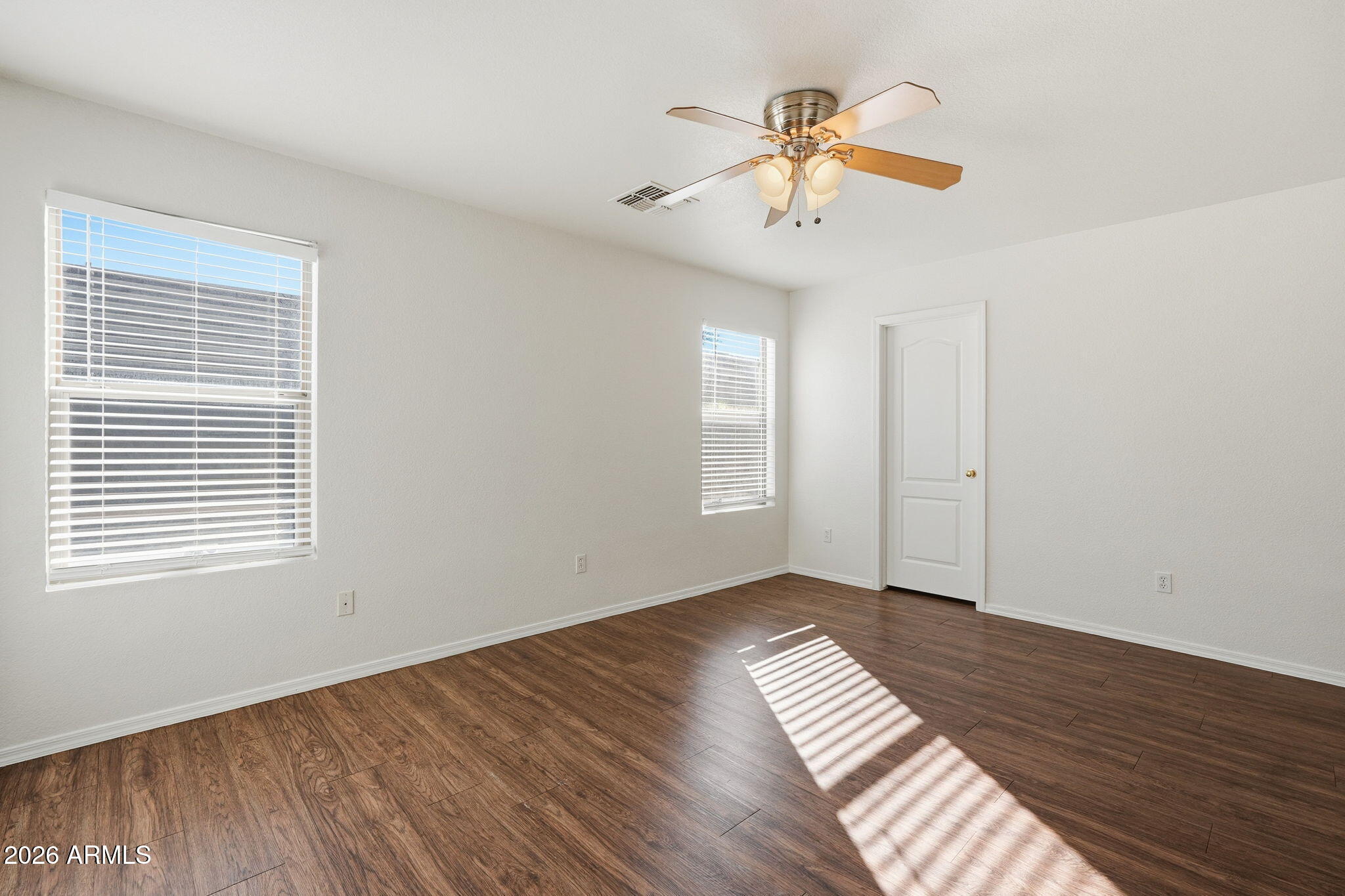 211 East Valley View Drive Phoenix, AZ 85042 - Photo 23 of 47 a view of an empty room with wooden floor and a window