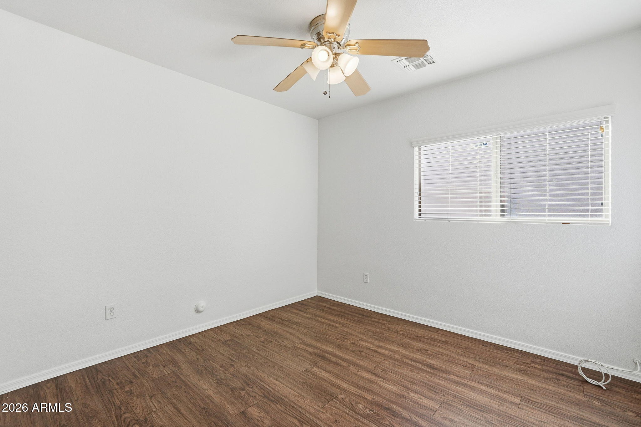211 East Valley View Drive Phoenix, AZ 85042 - Photo 25 of 47 wooden floor in an empty room with a window