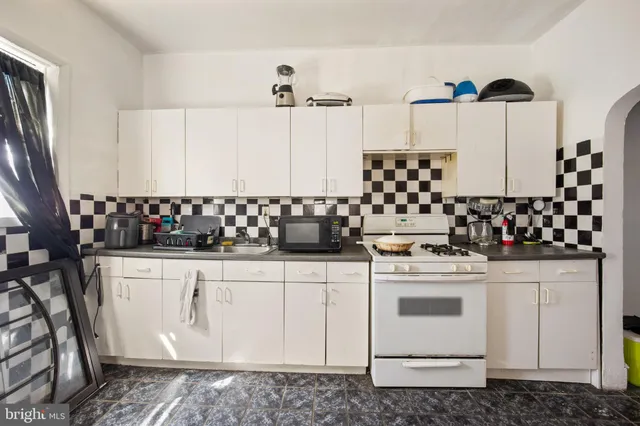 a kitchen with a stove and cabinets