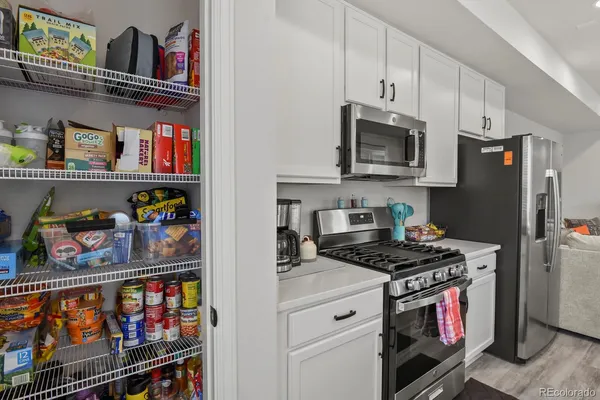 a kitchen with stainless steel appliances granite countertop a stove and a refrigerator