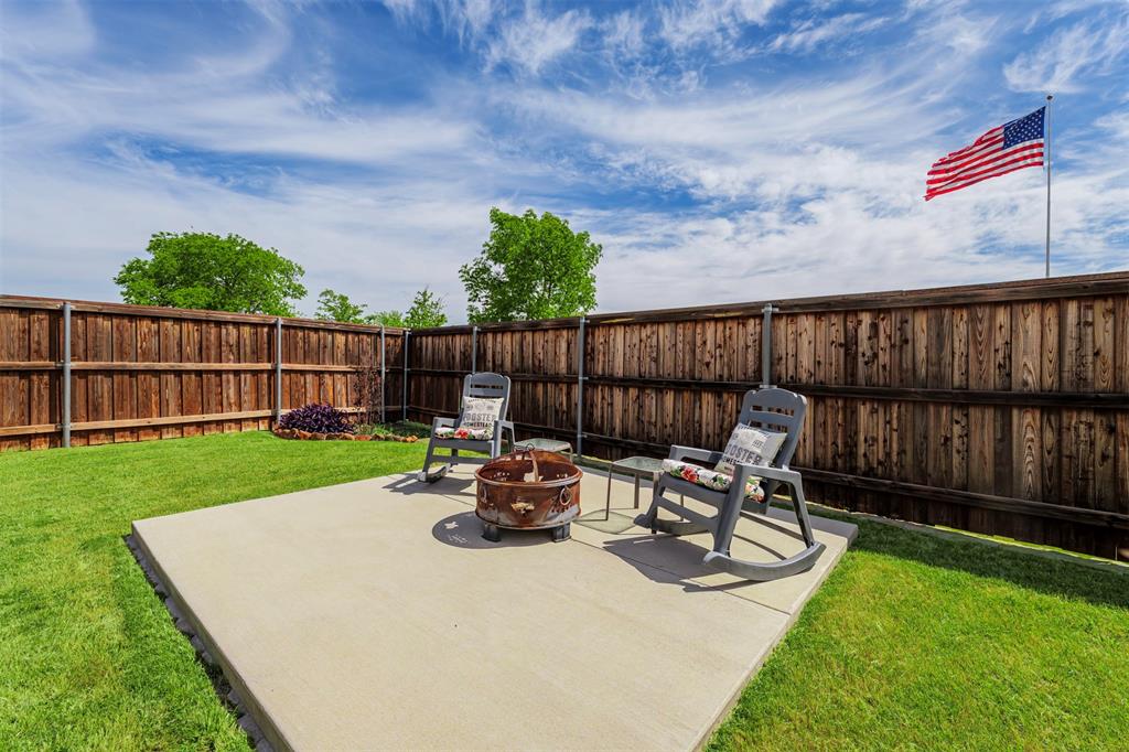 709 Bent Brook Road Oak Point, TX 75068 - Photo 17 of 24 Fenced backyard featuring a patio and a fire pit