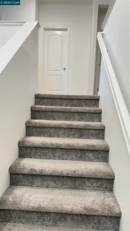 a utility room with a stove a microwave and cabinets