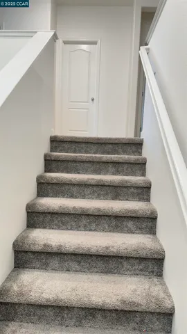 a utility room with a stove a microwave and cabinets