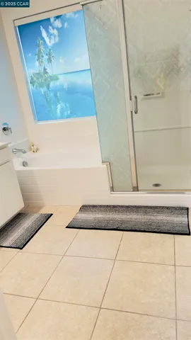 a bed sitting in a room next to a window