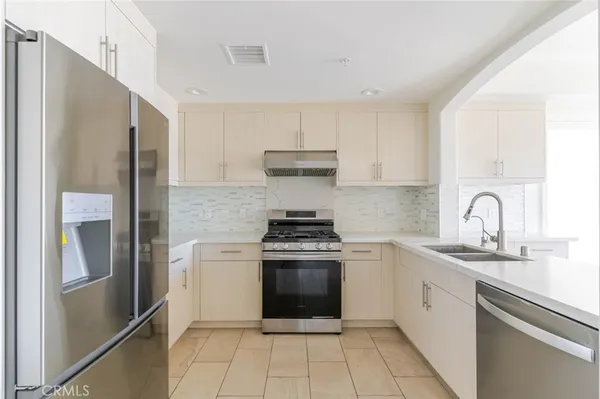 a kitchen with a stove sink and refrigerator