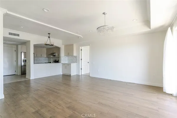 a view of a kitchen with a sink and a refrigerator