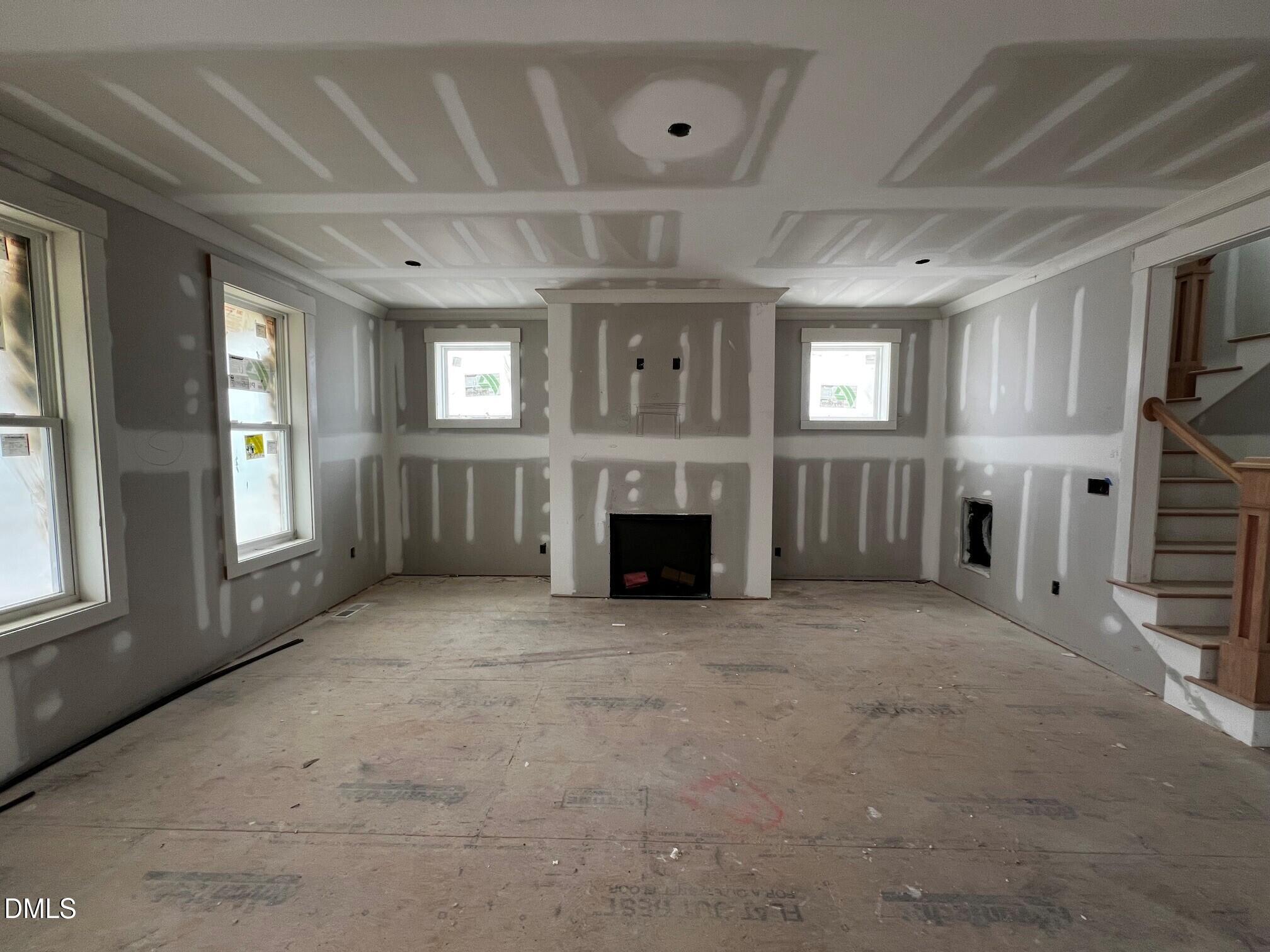 6051 Scalybark Road Durham, NC 27712 - Photo 3 of 53 a view of an empty room with a fireplace and a window