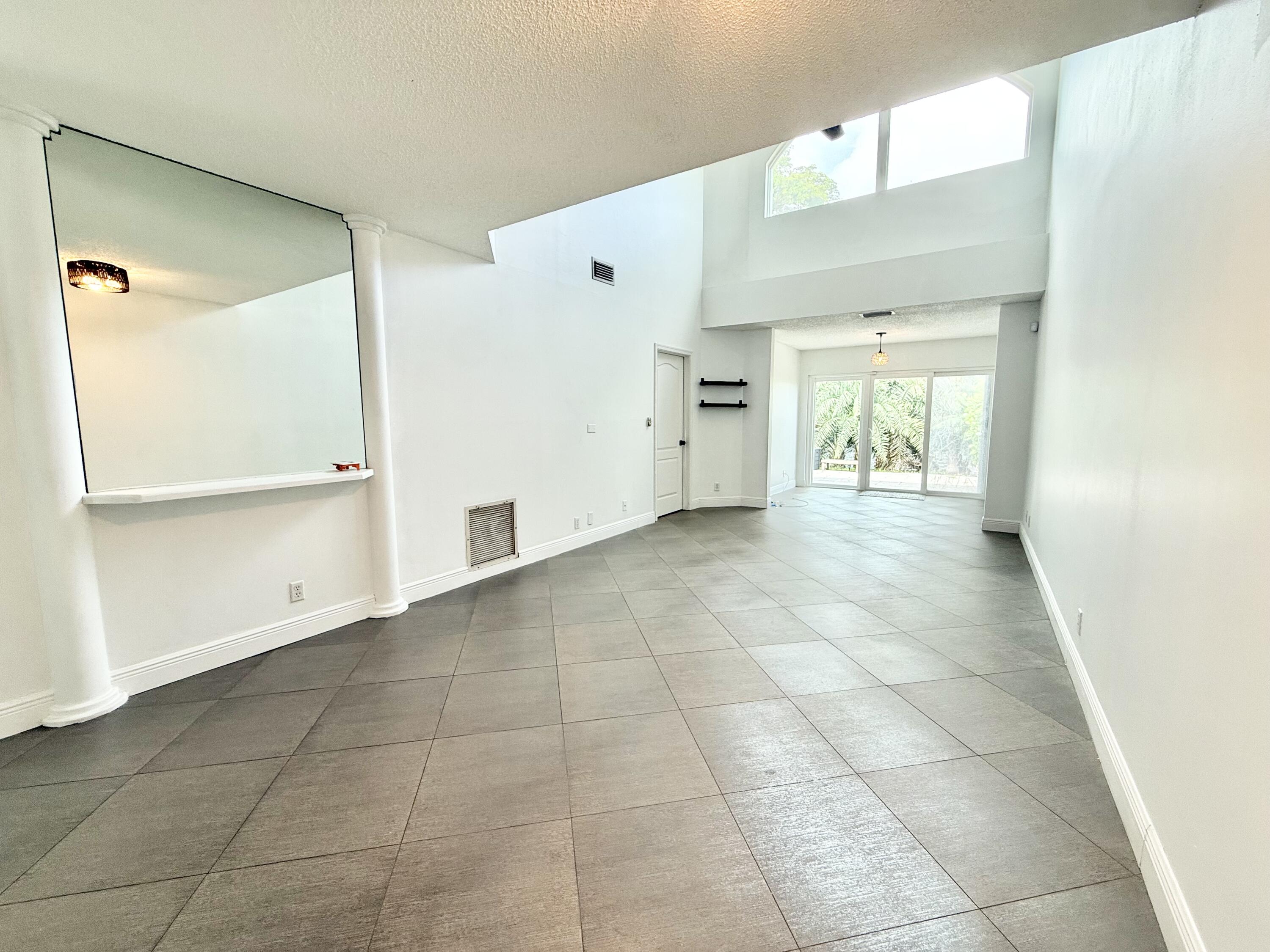 9190 Boca Gardens Parkway, Unit B Boca Raton, FL 33496 - Photo 6 of 35 a view of an empty room and window