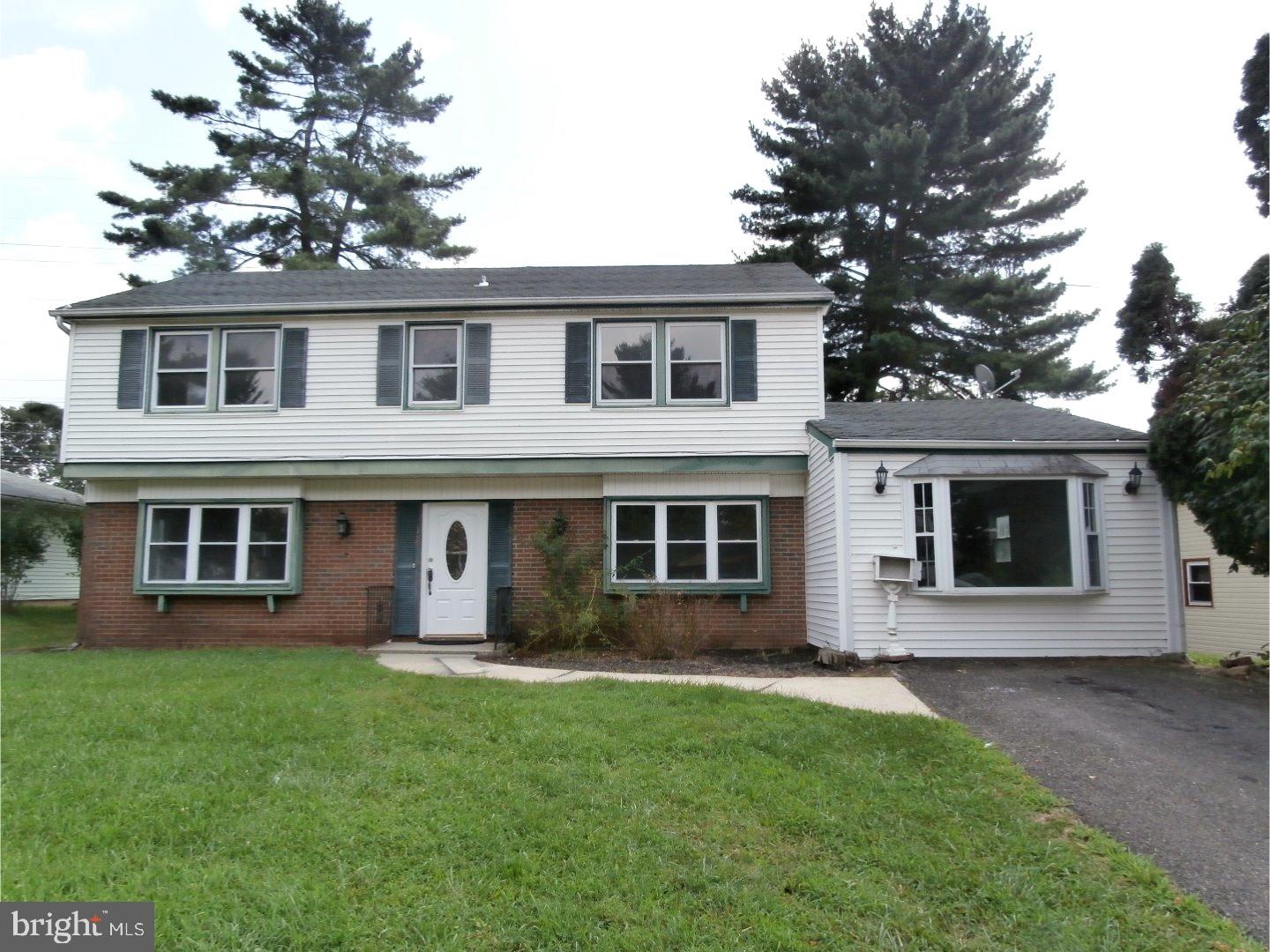 a view of a house with a yard and plants