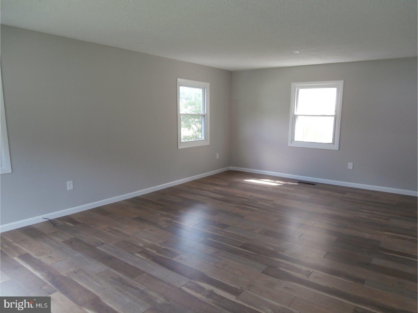 12 Hasting Lane Willingboro, NJ 08046 - Photo 2 of 13 a view of an empty room with wooden floor and window