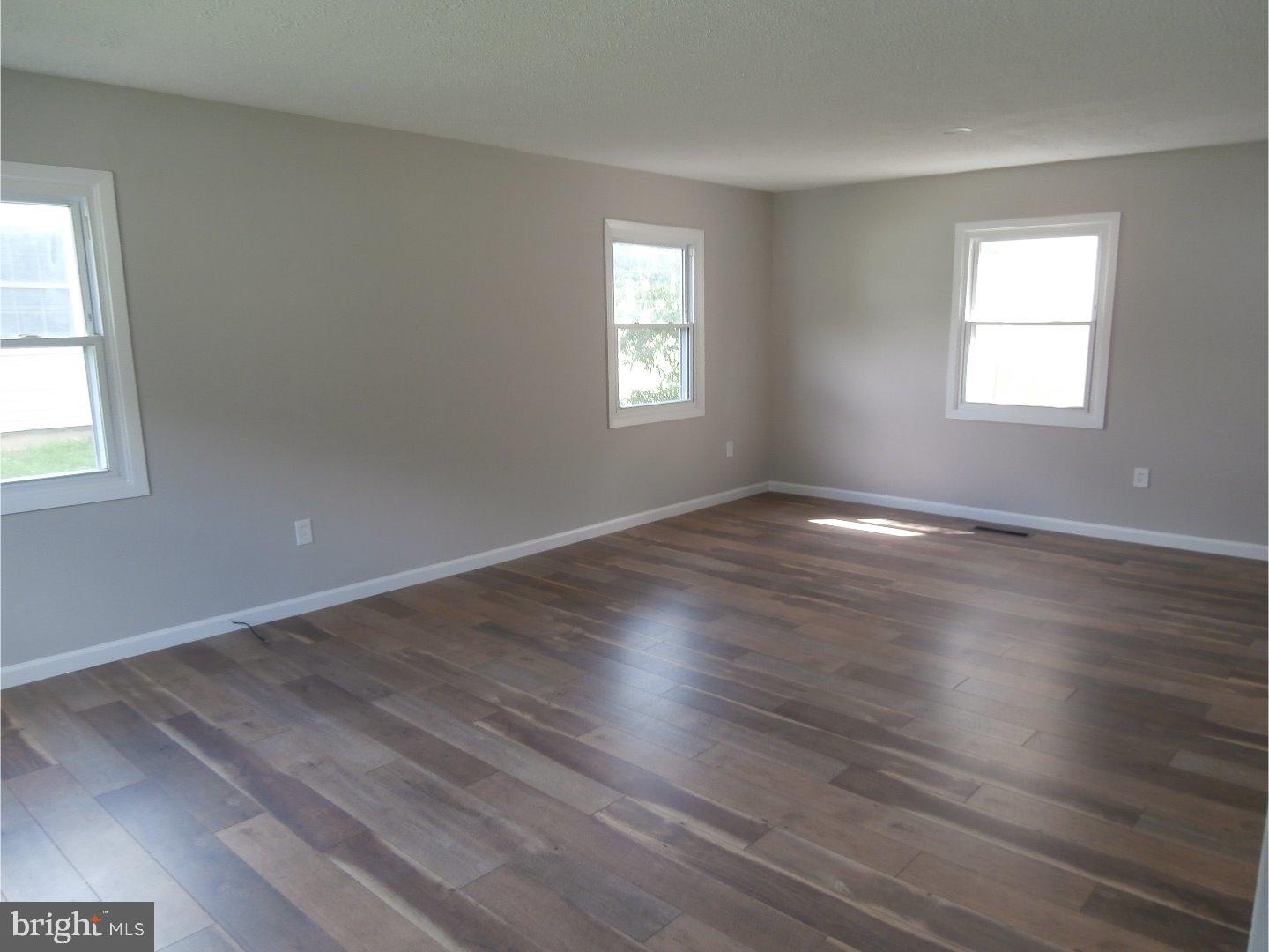 12 Hasting Lane Willingboro, NJ 08046 - Photo 3 of 13 an empty room with wooden floor and windows