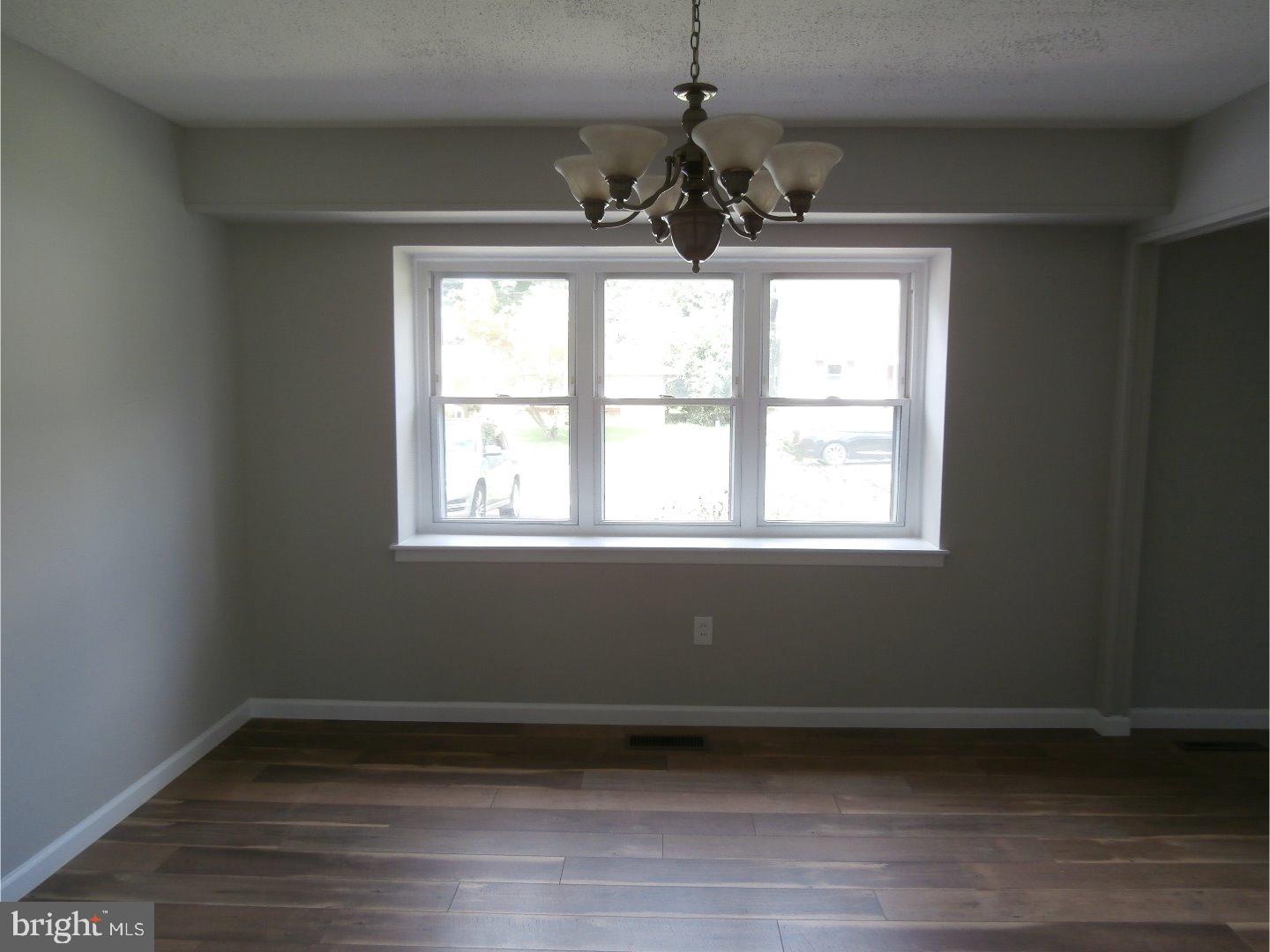 12 Hasting Lane Willingboro, NJ 08046 - Photo 4 of 13 a view of an empty room with wooden floor and a window