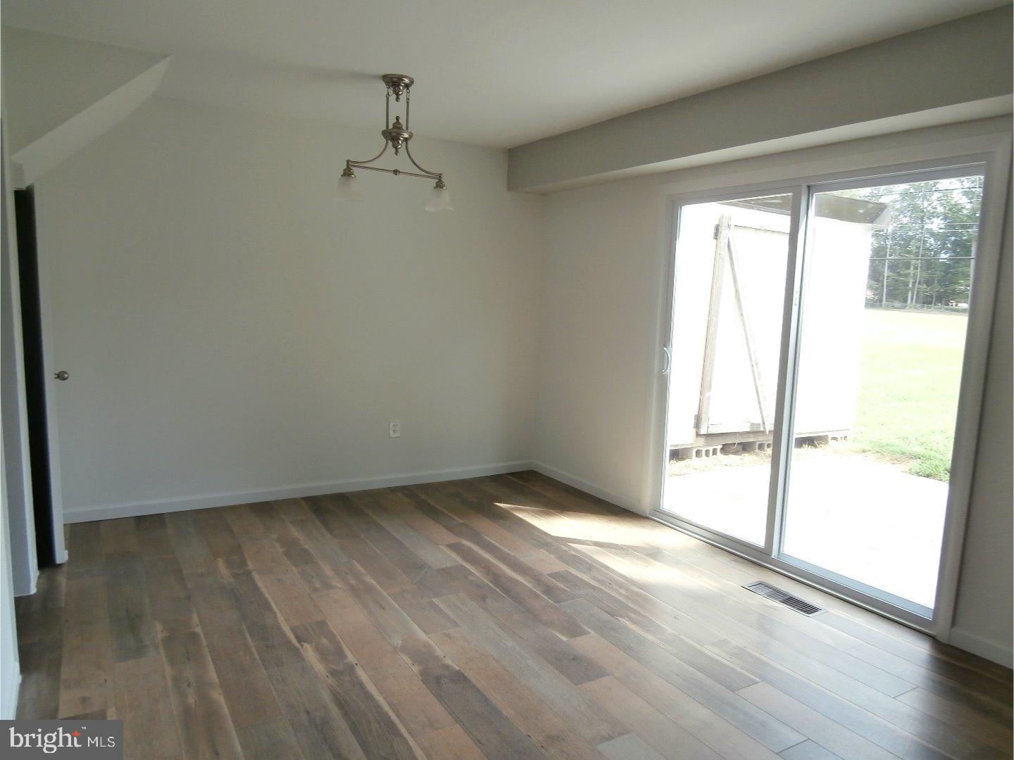 12 Hasting Lane Willingboro, NJ 08046 - Photo 8 of 13 an empty room with wooden floor and windows