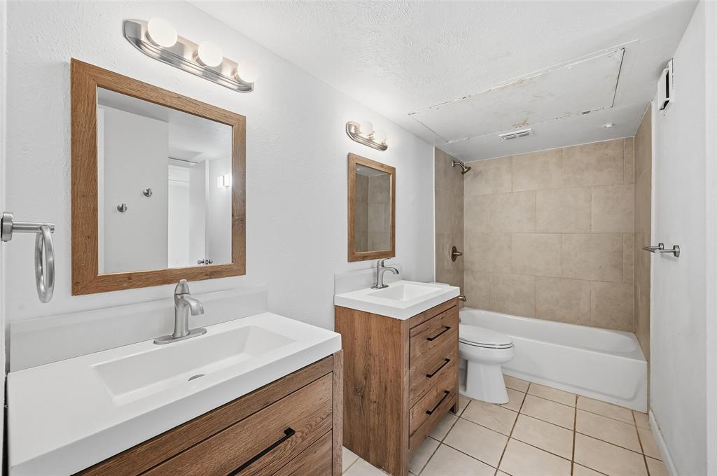 4645 Carr Street The Colony, TX 75056 - Photo 12 of 18 a bathroom with a sink a toilet a mirror and shower