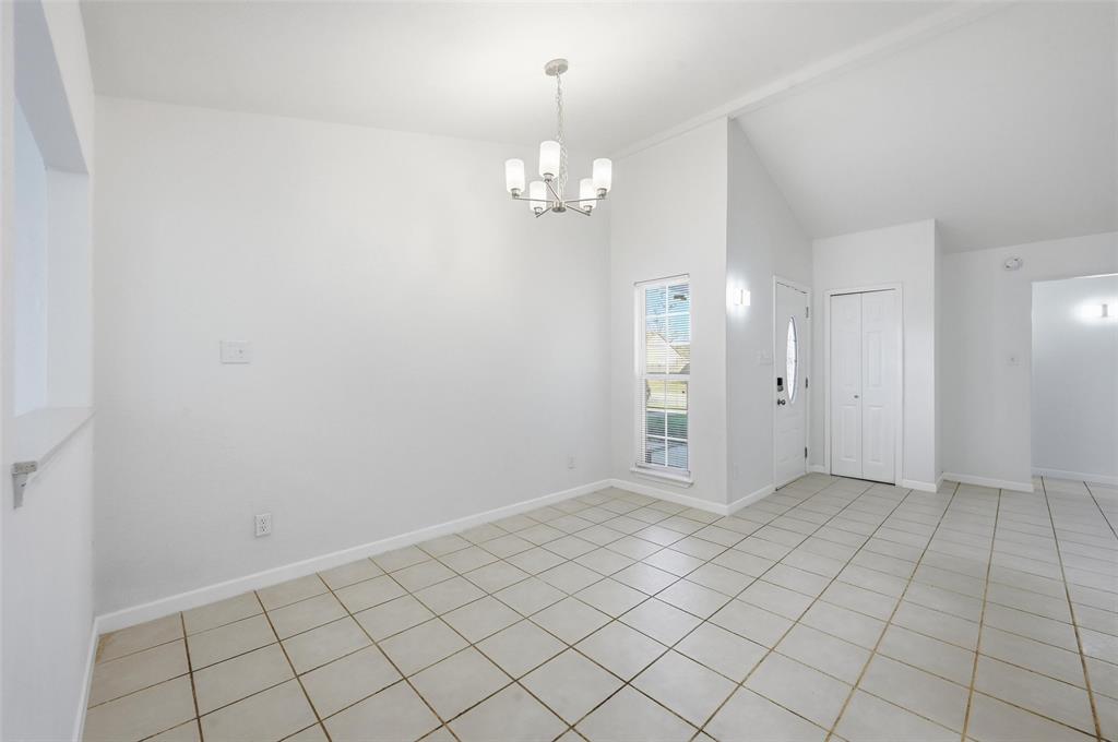 4645 Carr Street The Colony, TX 75056 - Photo 8 of 18 an empty room with kitchen view