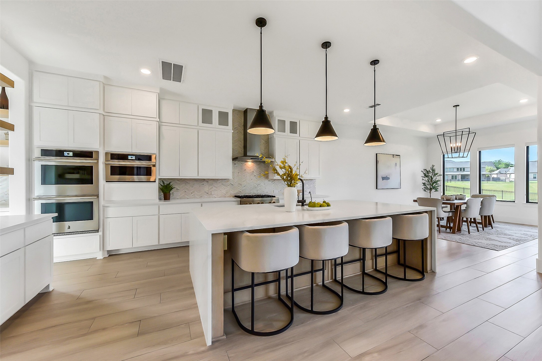 4903 Lagos Lagoon Way Spring, TX 77389 - Photo 12 of 49 Gourmet kitchen appointed with premium high-end appliances, including a 6-burner gas range, double ovens, built-in microwave, and refrigerator, complemented by reverse osmosis drinking water.