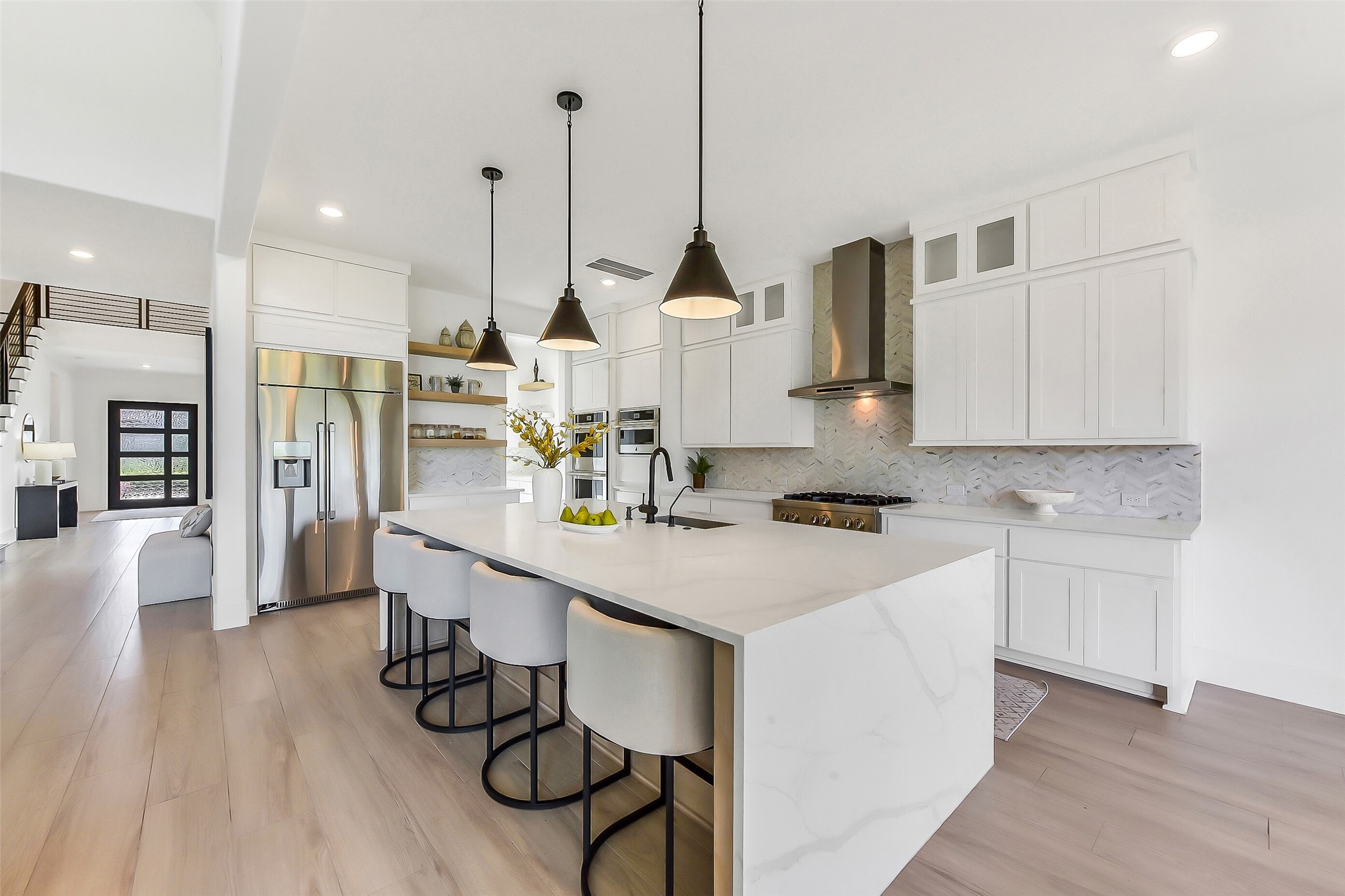 4903 Lagos Lagoon Way Spring, TX 77389 - Photo 13 of 49 Another view of the kitchen featuring the over-sized quartz counter, waterfall island and full-height cabinetry.