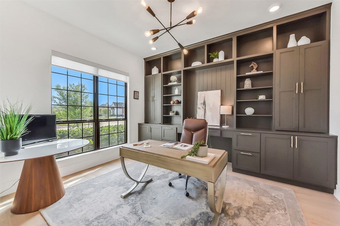 4903 Lagos Lagoon Way Spring, TX 77389 - Photo 9 of 49 Designer study with floor-to-ceiling built-ins, statement lighting in a bright and inspiring workspace.