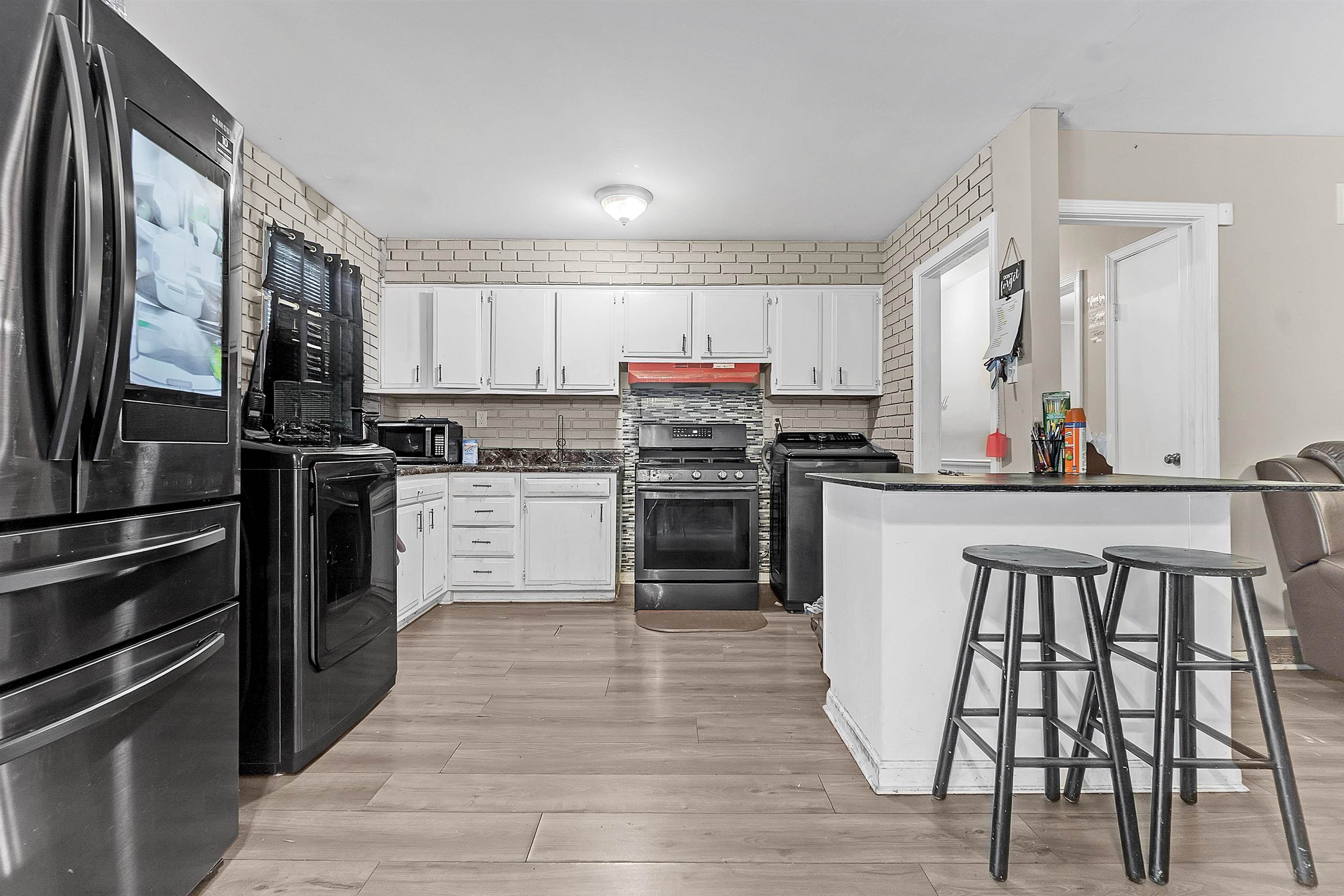4159 Cochese Road Memphis, TN 38118 - Photo 7 of 18 a kitchen with stainless steel appliances a stove top oven and a refrigerator