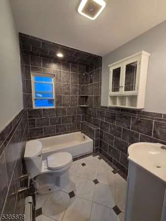 a bathroom with a toilet a sink and bathtub