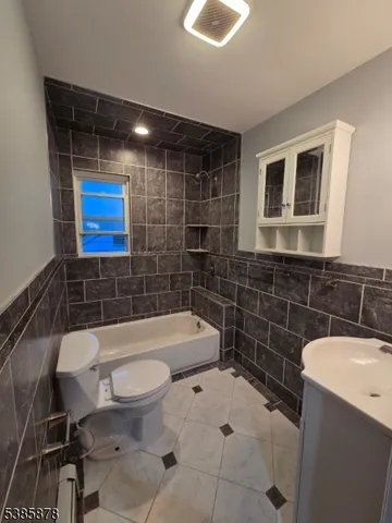 a bathroom with a toilet a sink and bathtub