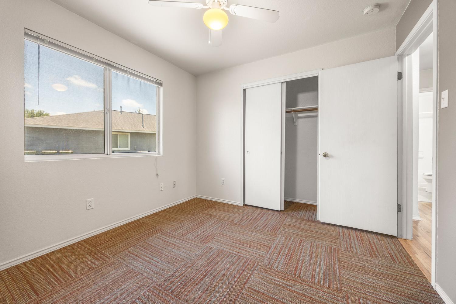 359 Spring Branch Loop Kyle, TX 78640 - Photo 12 of 17 a view of an empty room with wooden floor and a window