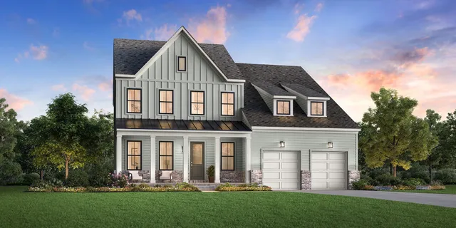 a front view of a house with a yard and green space