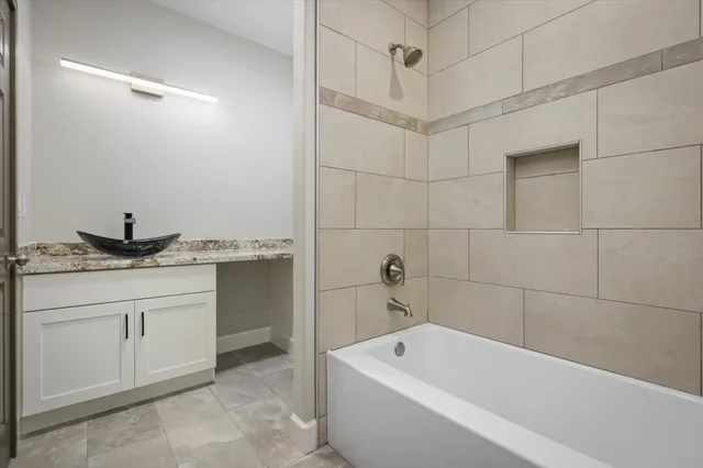 a bedroom with furniture and a large window