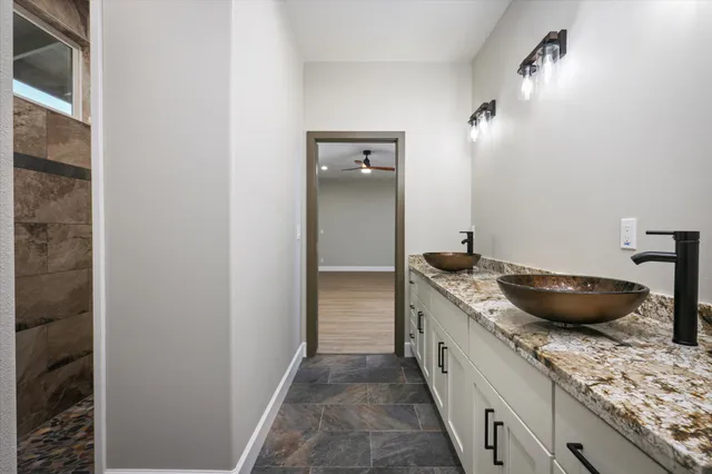 a front view of a house with a garden and trees