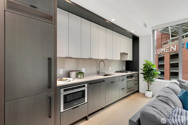 a kitchen with stainless steel appliances a stove a sink and a refrigerator